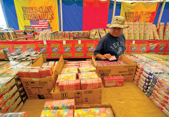 Michael Begay peruses the selection of fireworks at American Eagle Fireworks in Gallup on Tuesday. &copy; 2011 Gallup Independent / Adron Gardner 